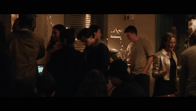A Man Touches A Woman 'S Face In A Kitchen With A Fridge That Says ' A ' On It GIF