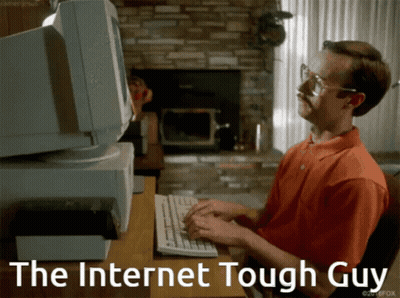 A Man Typing On A Keyboard With The Words " The Internet Tough Guy " Behind Him GIF