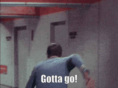 A Man Walking Down A Hallway With Gotta Go Written On The Wall Behind Him GIF