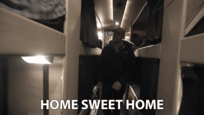 A Man Walking Down A Hallway With The Words Home Sweet Home Above Him GIF