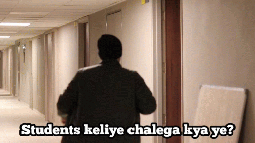 A Man Walking Down A Hallway With The Words Students Keliye Chalaga Kya Ye GIF