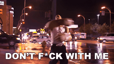 A Man Walking Down A Street With The Words " Don 'T F * Ck With Me " Written On The Bottom GIF