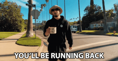 A Man Walking Down A Street With The Words " You 'Ll Be Running Back " Below Him GIF