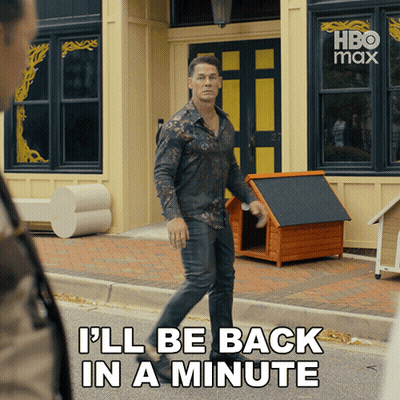 A Man Walking Down The Street With The Words " I 'Ll Be Back In A Minute " On The Bottom GIF