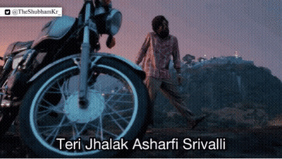 A Man Walking In Front Of A Motorcycle That Says Teri Jhalak Ashari Srivali GIF