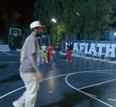 A Man Walking On A Basketball Court In Front Of A Wall That Says Faith GIF