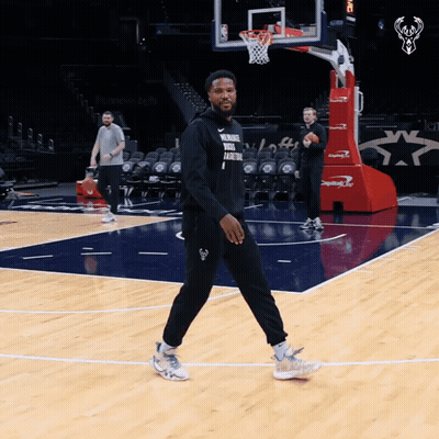 A Man Walking On A Basketball Court Wearing A Shirt That Says " Remember Your Basketball 1 " GIF