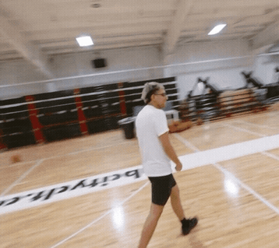 A Man Walking On A Basketball Court With The Word Barych Written On The Floor GIF