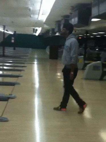 A Man Walking On A Bowling Alley Wearing A Sweatshirt That Says Los Angeles On It GIF