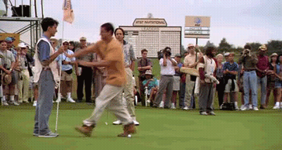 A Man Walking On A Golf Course With A Sign That Says At & T National GIF