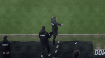 a man walking on a soccer field wearing a shirt that says ' do ' on it