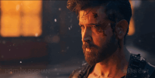 A Man Walking With A Wolf In Front Of A Building With The Name Hrithik Roshan On The Bottom GIF