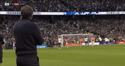 A Man Watches A Soccer Game With A Banner That Says Johannes Purs On It GIF