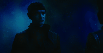 A Man Waves His Hand With The Words Live Long Behind Him GIF