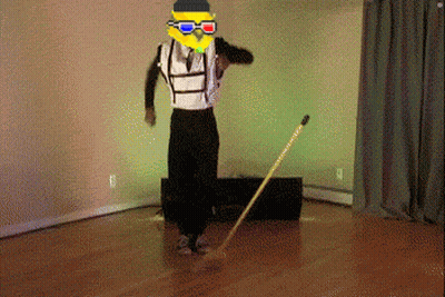 A Man Wearing 3D Glasses And A Yellow Mask Is Standing On A Wooden Floor GIF