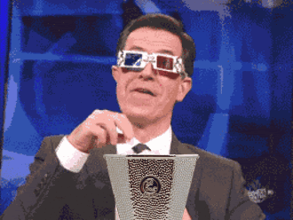 A Man Wearing 3D Glasses Is Holding A Cup GIF