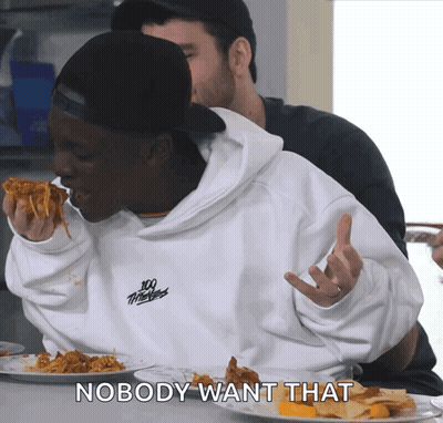 A Man Wearing A 100 Thieves Sweatshirt Is Eating A Slice Of Pizza GIF