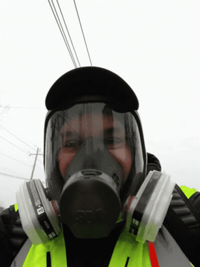 A Man Wearing A 3M Gas Mask With Two Filters GIF