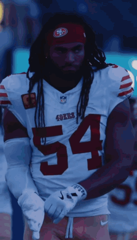 A Man Wearing A 49Ers Jersey With The Number 54 On The Front GIF