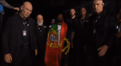 A Man Wearing A Badge That Says Ufc Walks Through A Crowd GIF