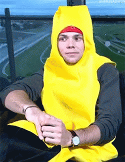 A Man Wearing A Banana Costume Is Sitting On A Chair GIF