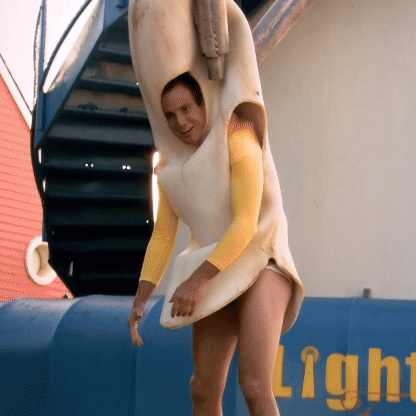 A Man Wearing A Banana Costume Is Standing In Front Of A Sign That Says Light GIF