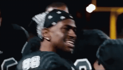 A Man Wearing A Bandana And A Number 88 Jersey Is Smiling . GIF