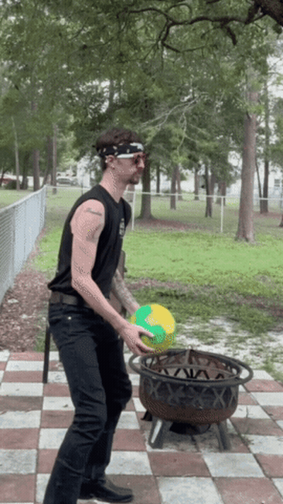 A Man Wearing A Bandana And Sunglasses Is Throwing A Ball In A Fire Pit GIF