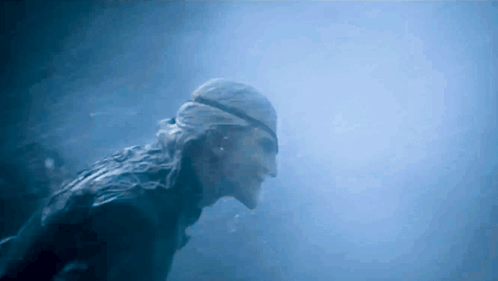 A Man Wearing A Bandana Is Swimming In The Water GIF