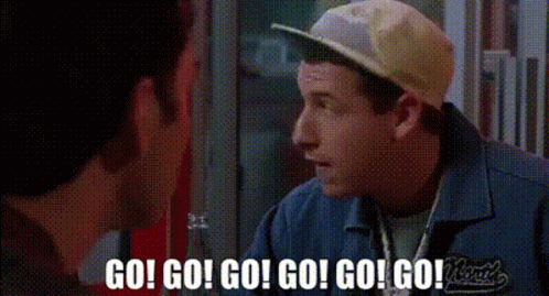 A Man Wearing A Baseball Cap And A Blue Shirt Is Talking To Another Man . GIF