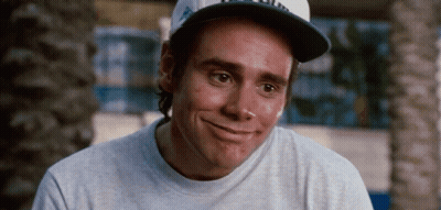 A Man Wearing A Baseball Cap And A Gray Shirt Smiles GIF