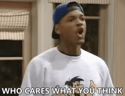 A Man Wearing A Baseball Cap And A T-Shirt With The Words Who Cares What You Think On It GIF