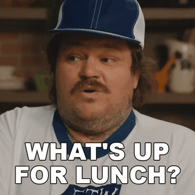 A Man Wearing A Baseball Cap And A White Shirt Says What 'S Up For Lunch GIF