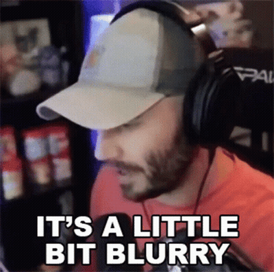 A Man Wearing A Baseball Cap And Headphones Says It 'S A Little Bit Blurry GIF