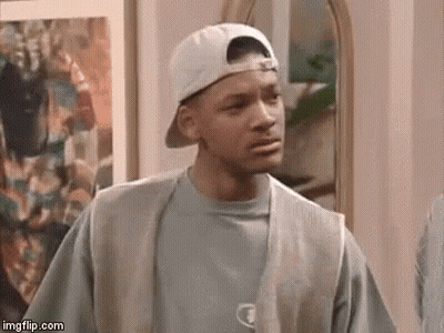 A Man Wearing A Baseball Cap And Vest Is Standing In Front Of A Mirror . GIF