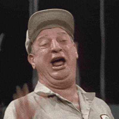 A Man Wearing A Baseball Cap Is Making A Funny Face . GIF