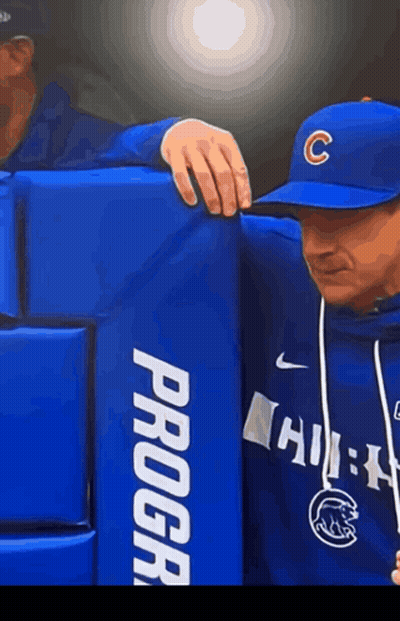 A Man Wearing A Baseball Cap With The Letter C On It Leans On A Blue Progear Block GIF