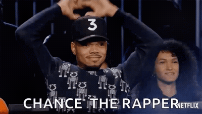 A Man Wearing A Baseball Cap With The Number 3 On It Is Holding His Hands In The Air . GIF