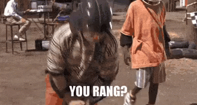 A Man Wearing A Baseball Helmet Is Holding A Bat And Says `` You Rang ? '' GIF