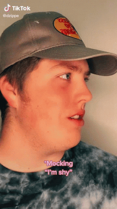 A Man Wearing A Bass Pro Shops Hat Says " Mocking " I 'M Shy " GIF
