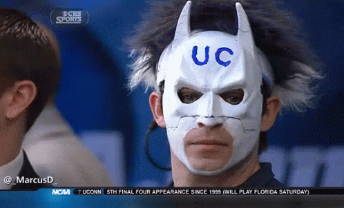A Man Wearing A Batman Mask That Says Uc On It GIF
