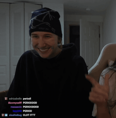 A Man Wearing A Beanie And A Black Hoodie Is Smiling In Front Of A Screen That Says Majorload08 GIF