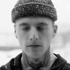A Man Wearing A Beanie And A Tattoo On His Neck GIF