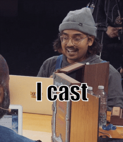 A Man Wearing A Beanie And Glasses Is Holding A Book And The Words I Cast Are Above Him GIF