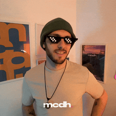 A Man Wearing A Beanie And Sunglasses With The Word Mcdh On The Bottom Right GIF