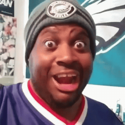 A Man Wearing A Beanie Is Making A Funny Face . GIF