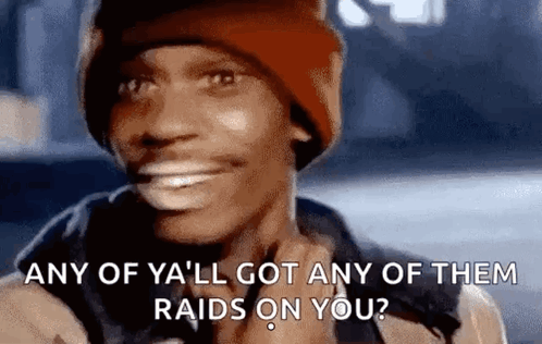 A Man Wearing A Beanie Is Smiling And Asking If He Has Any Of Them Raids On You . GIF