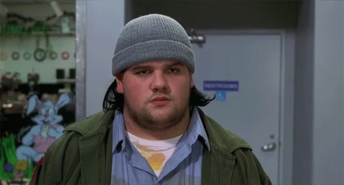 A Man Wearing A Beanie Is Standing In Front Of A Door That Says Destructions GIF
