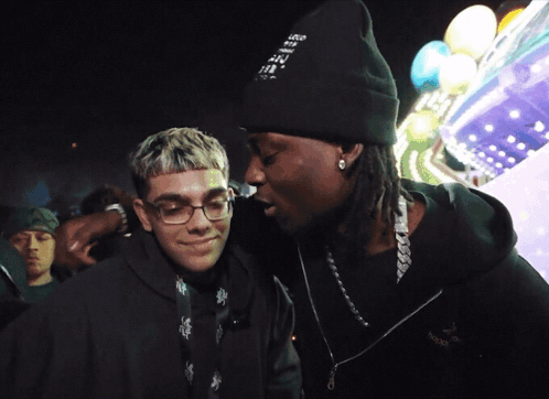 A Man Wearing A Beanie That Says " I Love You " Talks To Another Man GIF