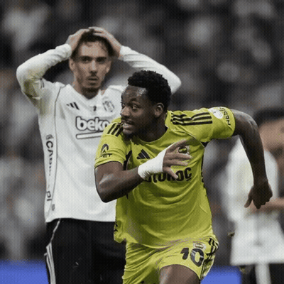 A Man Wearing A Beko Jersey Looks On As A Soccer Player Celebrates GIF